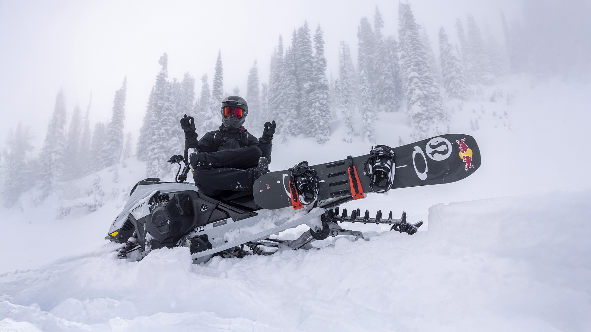 Ski-Doo rider in deep snow with accessories attached to his summit