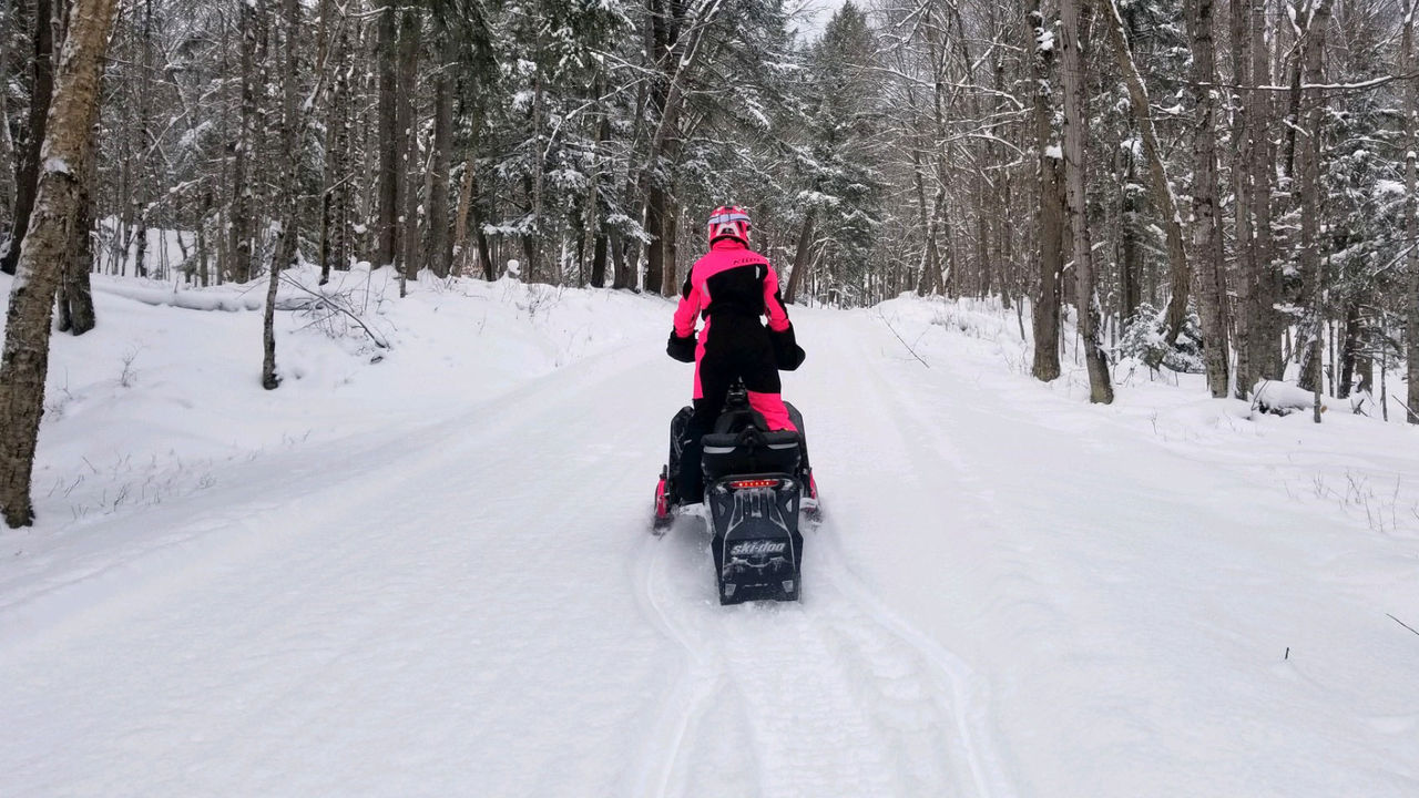 Tiffanie Hoops driving a Ski-Doo in trail
