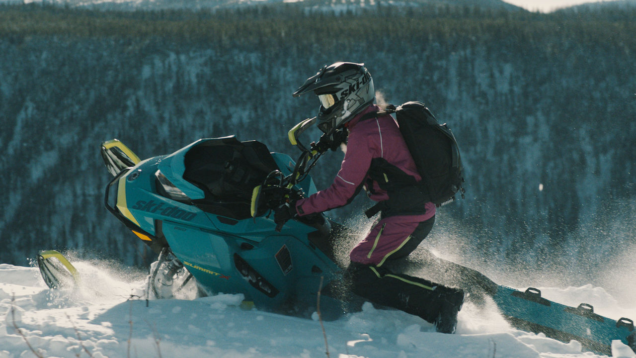 Sara Dufour riding a Ski-Doo in mountain