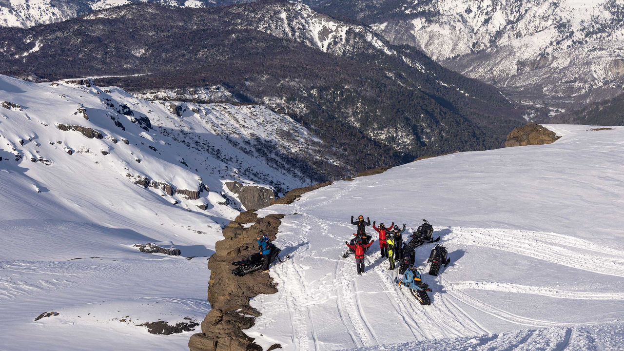 Group of Ski-Doo riders on the top on of a mountain in Chile