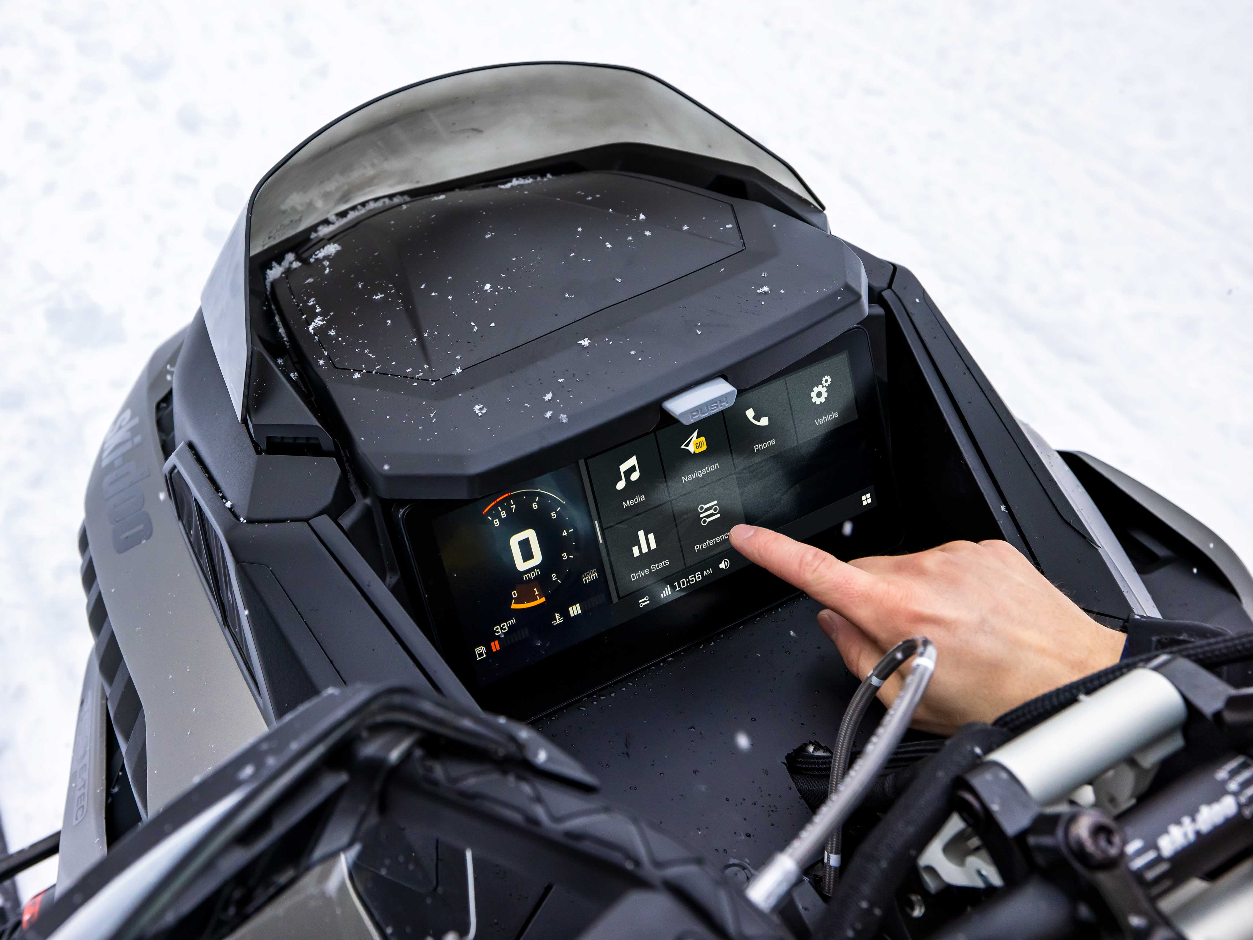 Rider using the touchscreen display on a Ski-Doo Renegade