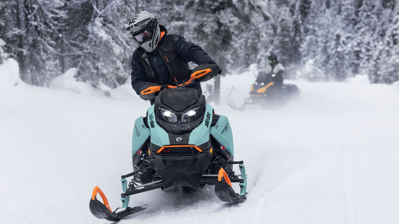 Two snowmobilers on their Ski-Doo Backcountry in trail