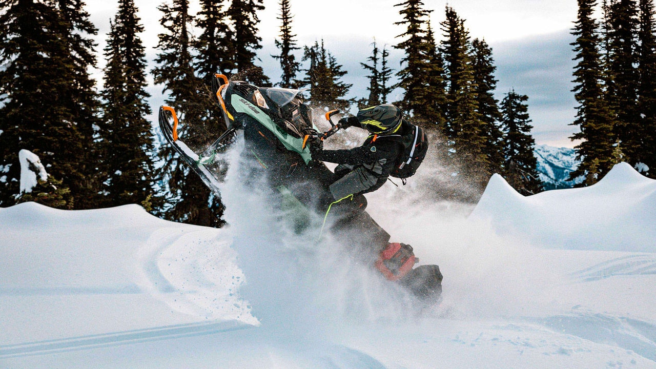 Man jumping while riding a Ski-Doo Expedition Xtreme