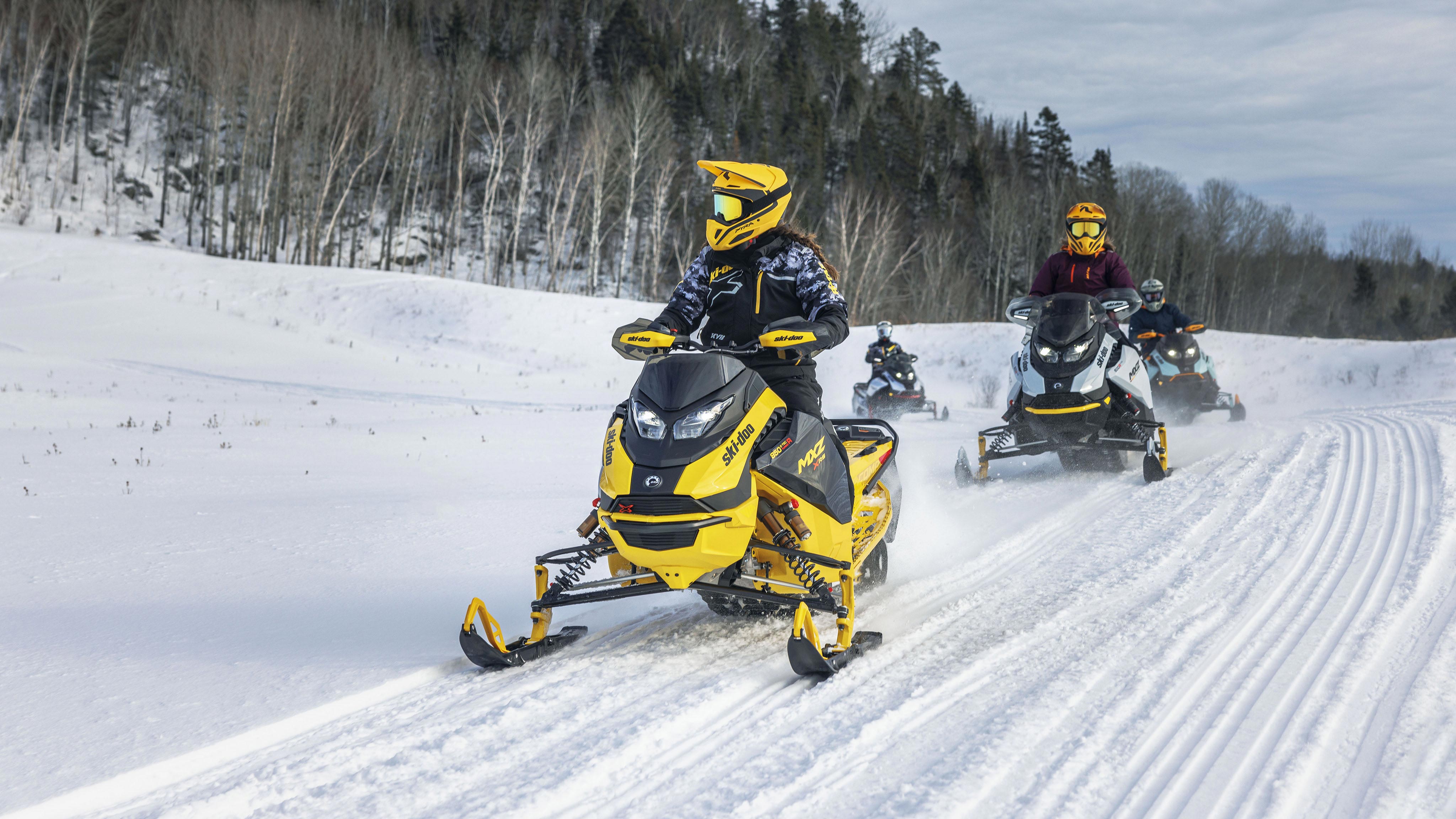 Four snowmobilers on their Ski-Doo in trail
