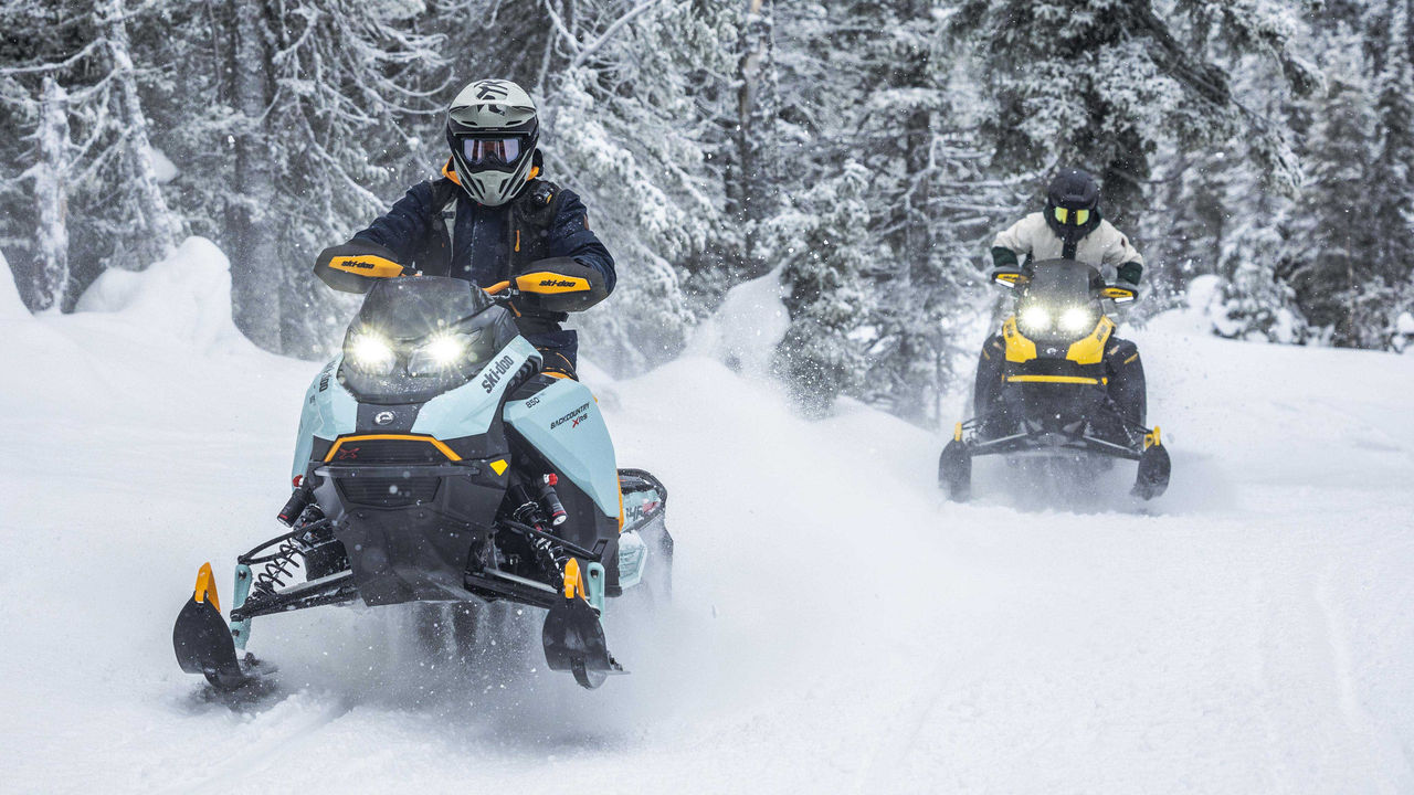 Two riders on their Ski-Doo Backcountry in trail