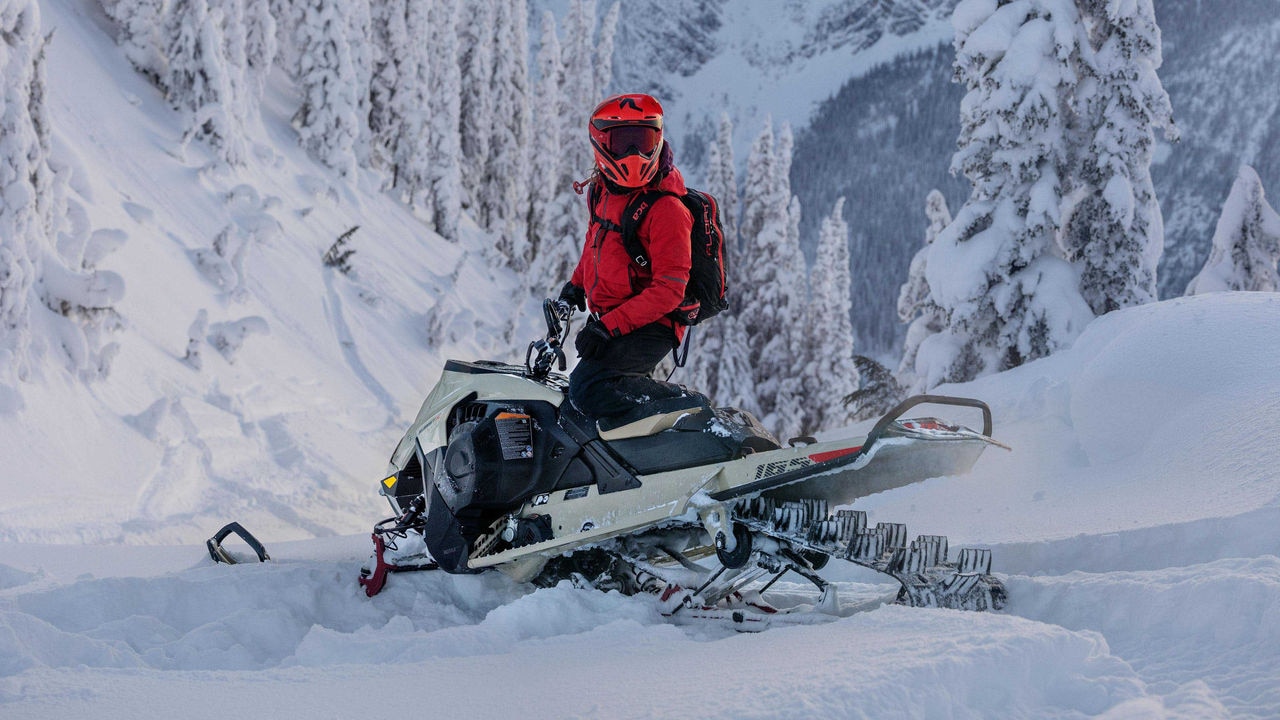 Rider standing on a Ski-Doo Summit and looking back