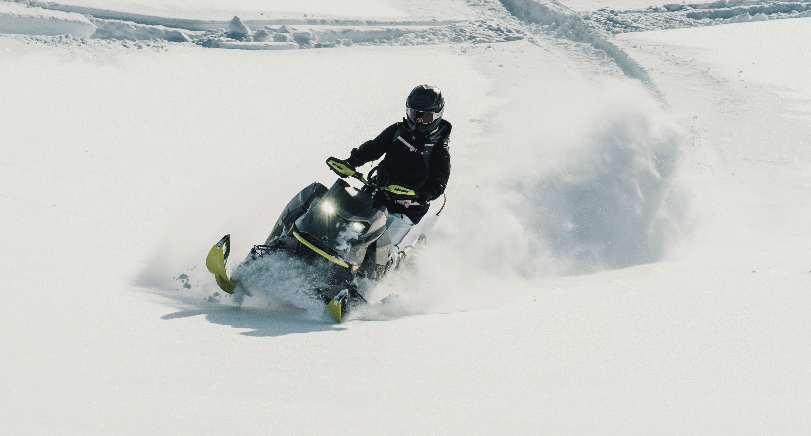 Jamie Anderson riding a Ski-Doo snowmobile in deep snow