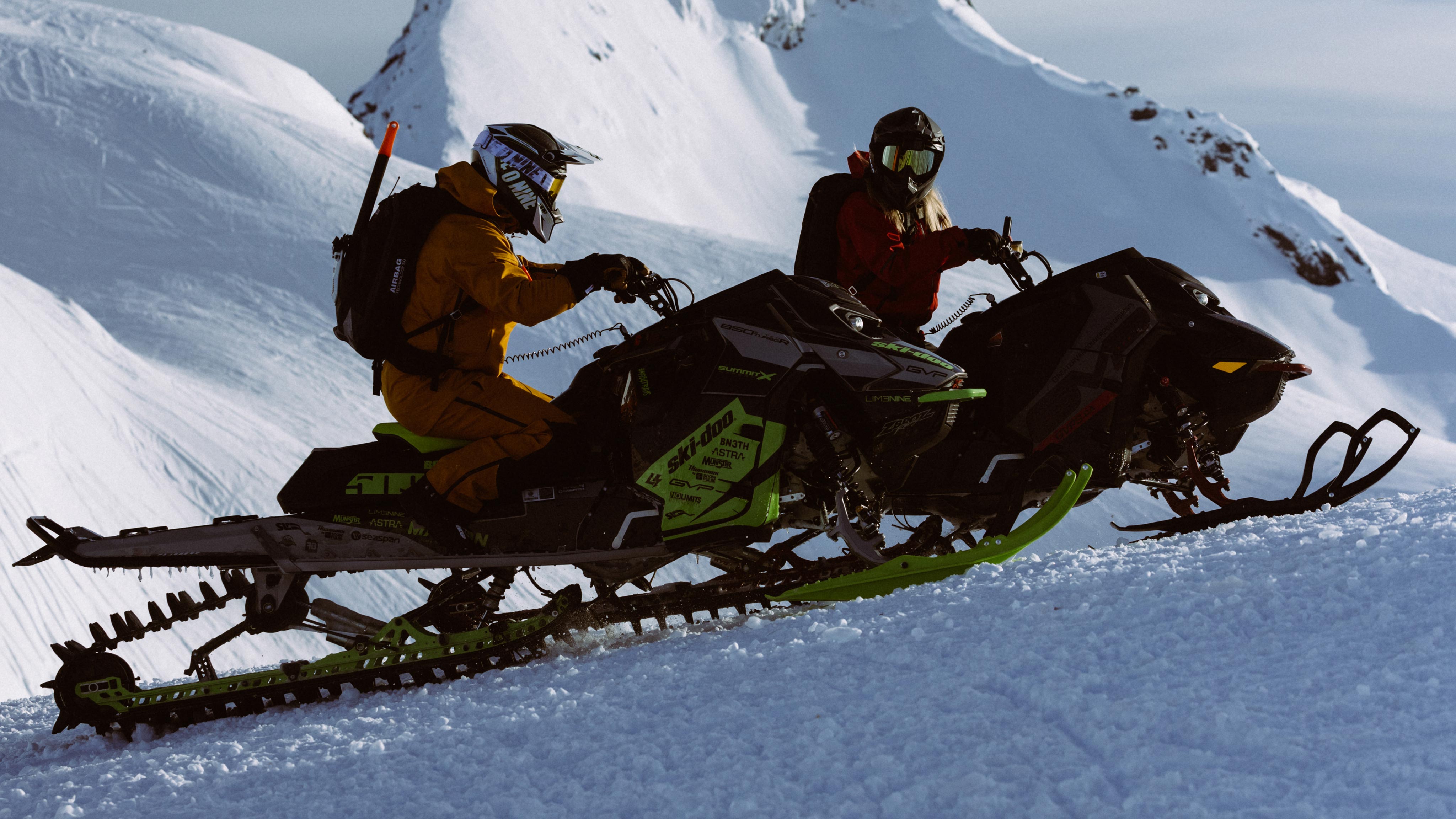 Cody McNolty and Ella Snäll on their Ski-Doo sleds