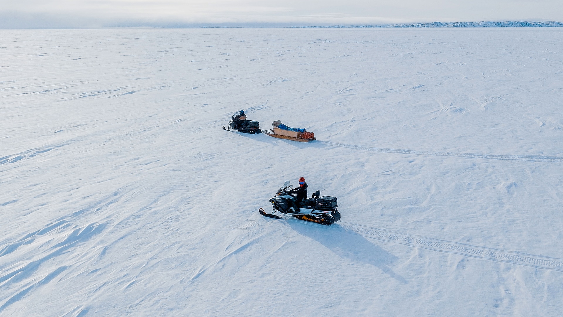 Two Ski-Doo snowmobiles riding in Nunavut