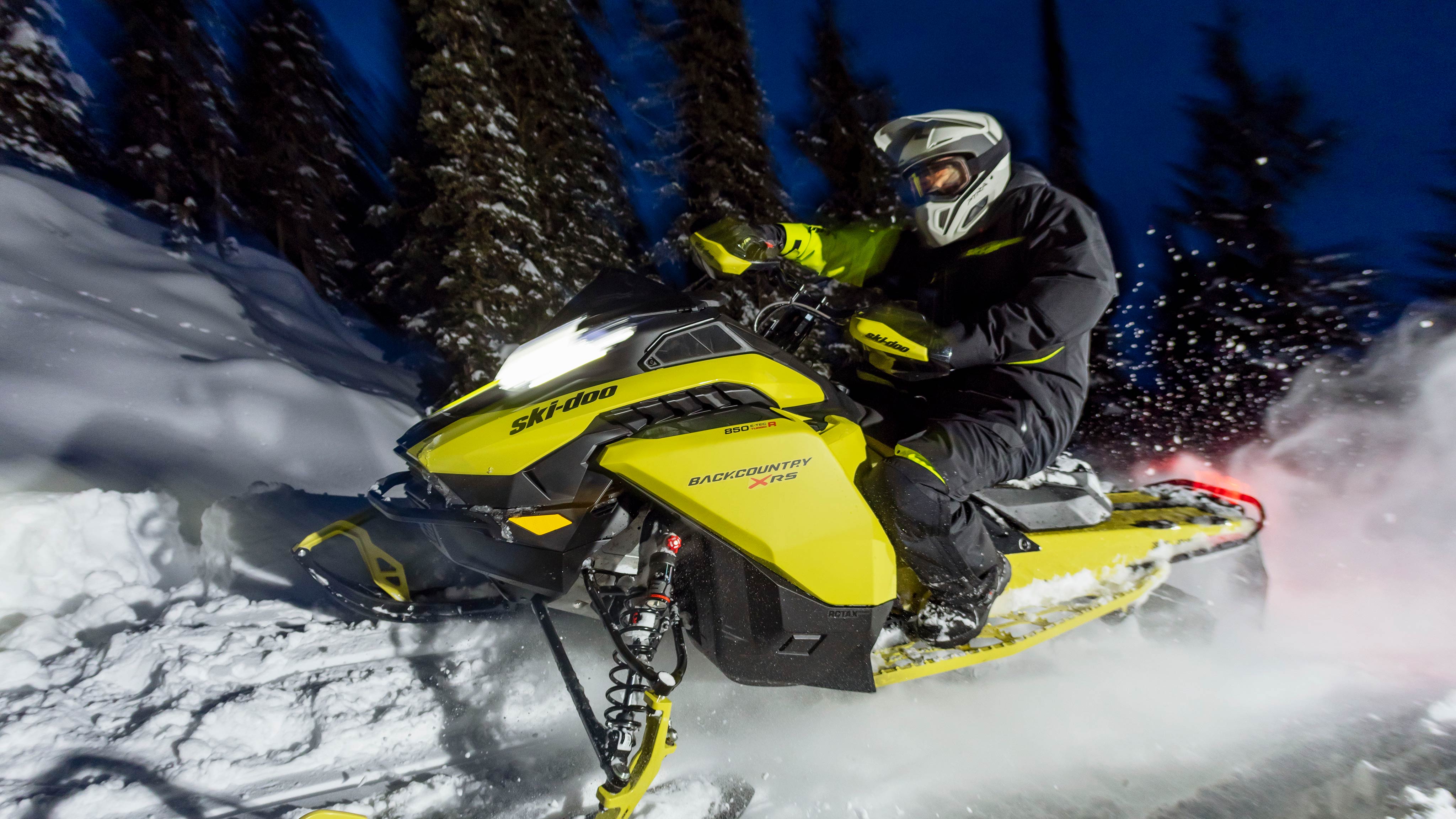 2025 Ski-Doo Crossover Backcountry snowmobile riding through fresh snow