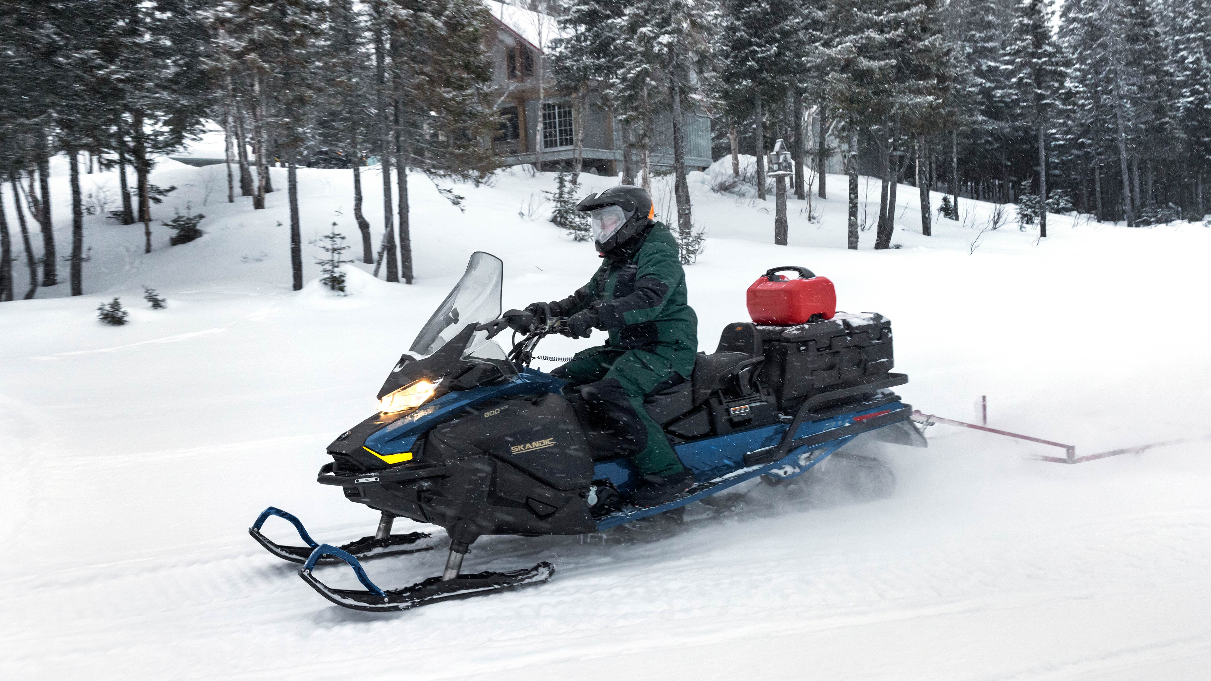 2025 Ski-Doo Skandic sport utility snowmobile riding in the snow
