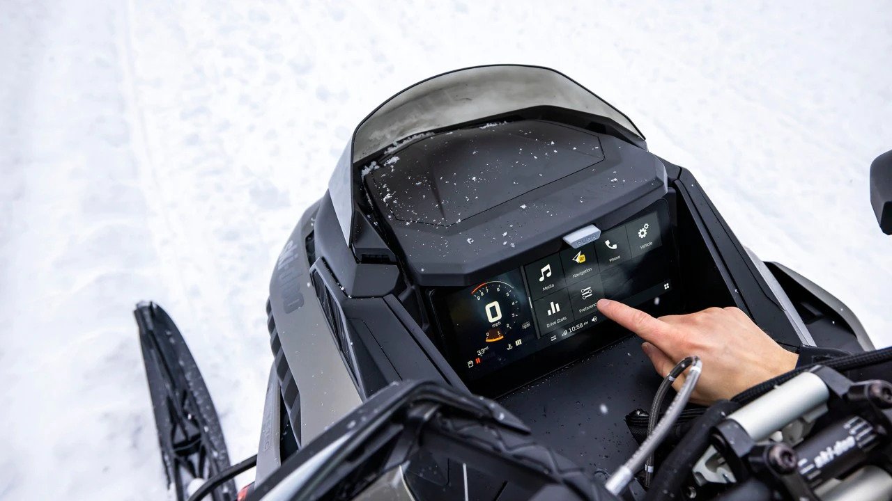 Close-up of the 10.25-inch touchscreen display on a Ski-Doo snowmobile displaying the speed and the main menu.