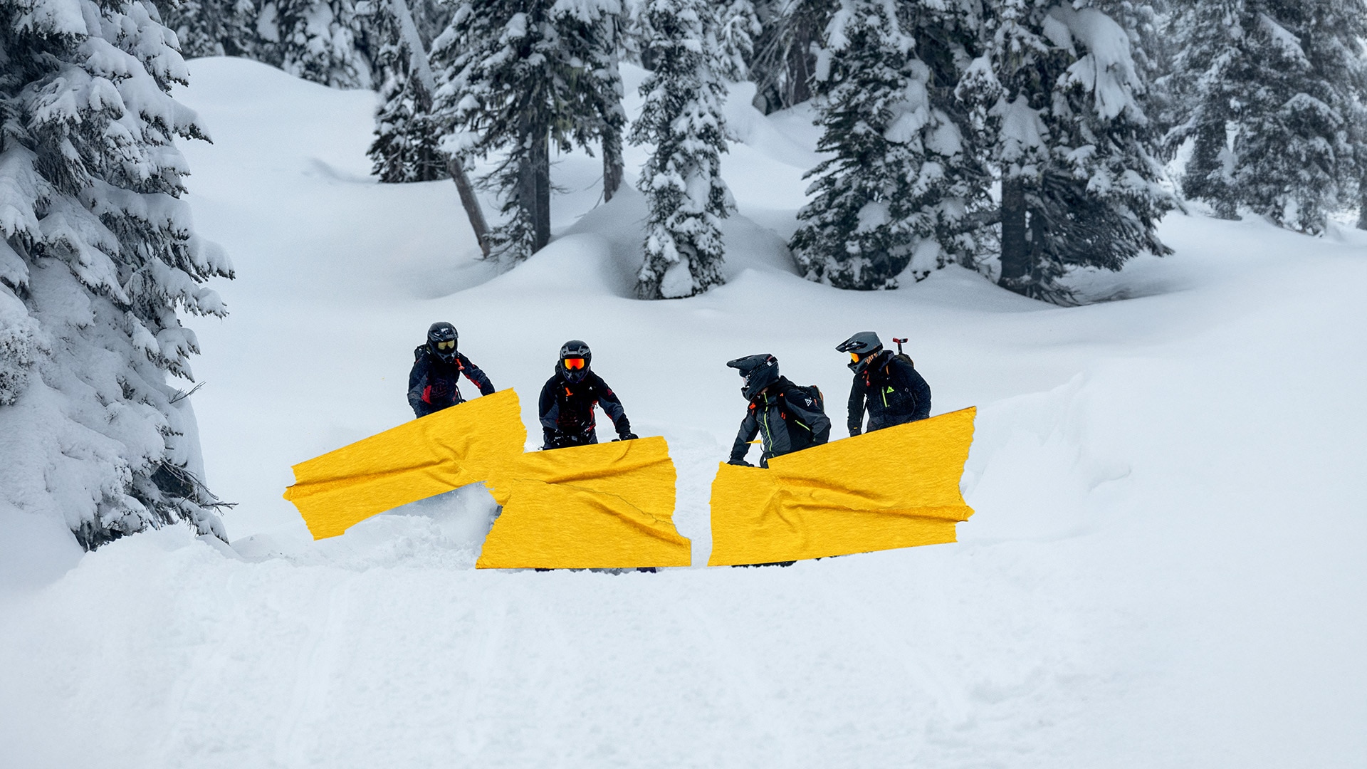 Four Ski-Doo snowmobile enthusiasts standing on a snowy hill