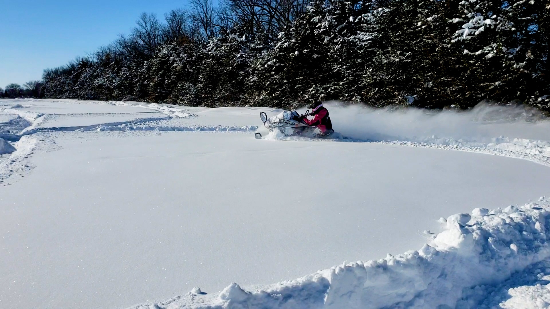 Ashleigh Abner snowmobiling in deep snow