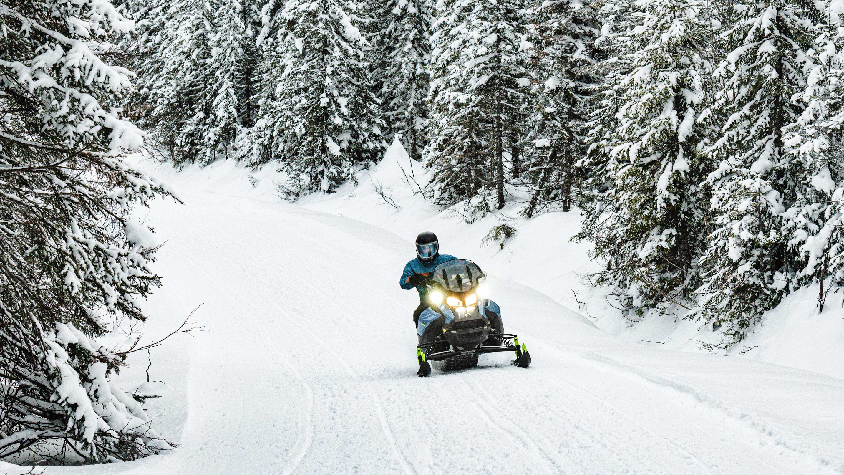 Man riding a 2022 Ski-Doo Renegade on a trail