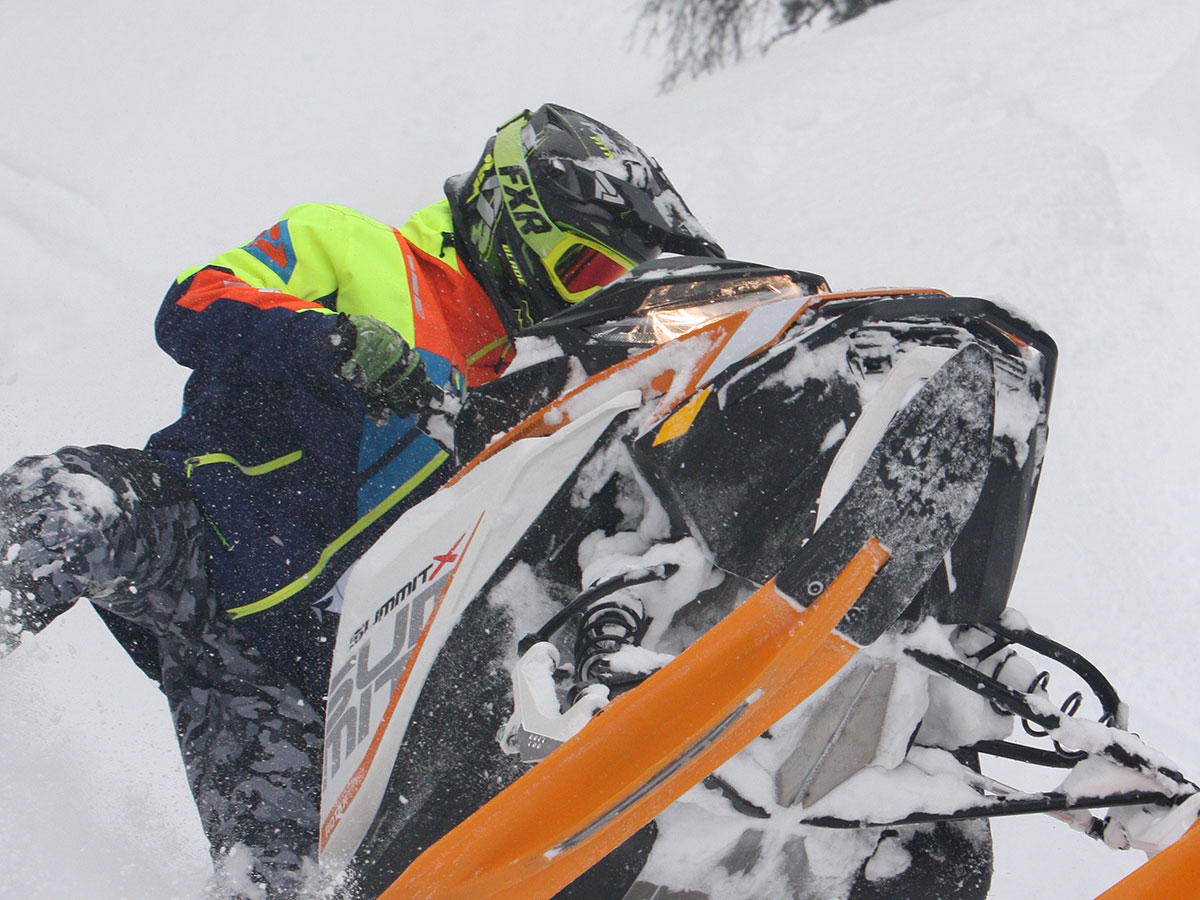 Bret Rasmussen riding snowmobile in Deep-Snow