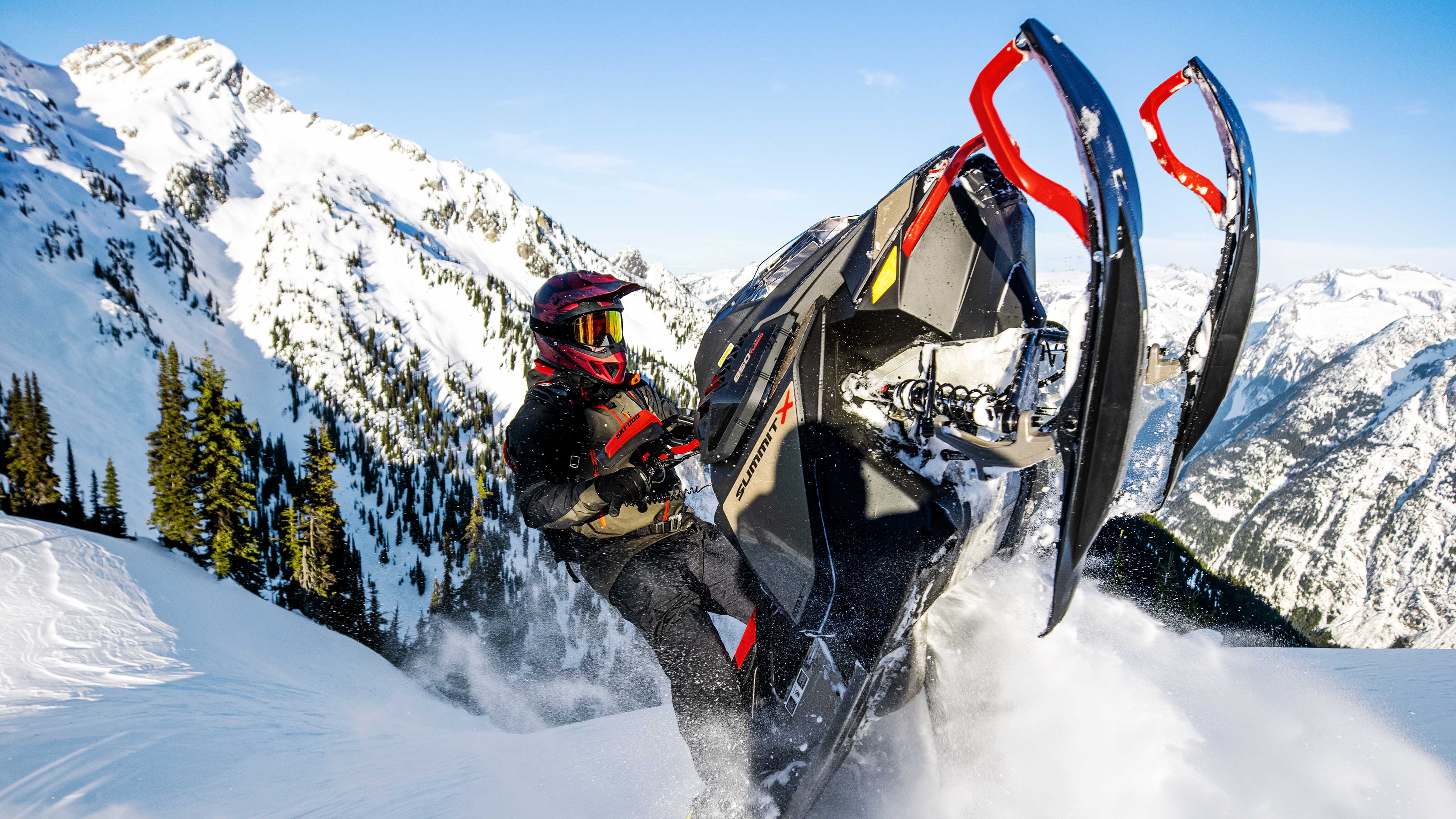 Men making a jump on his Ski-Doo Summit X with Expert Package