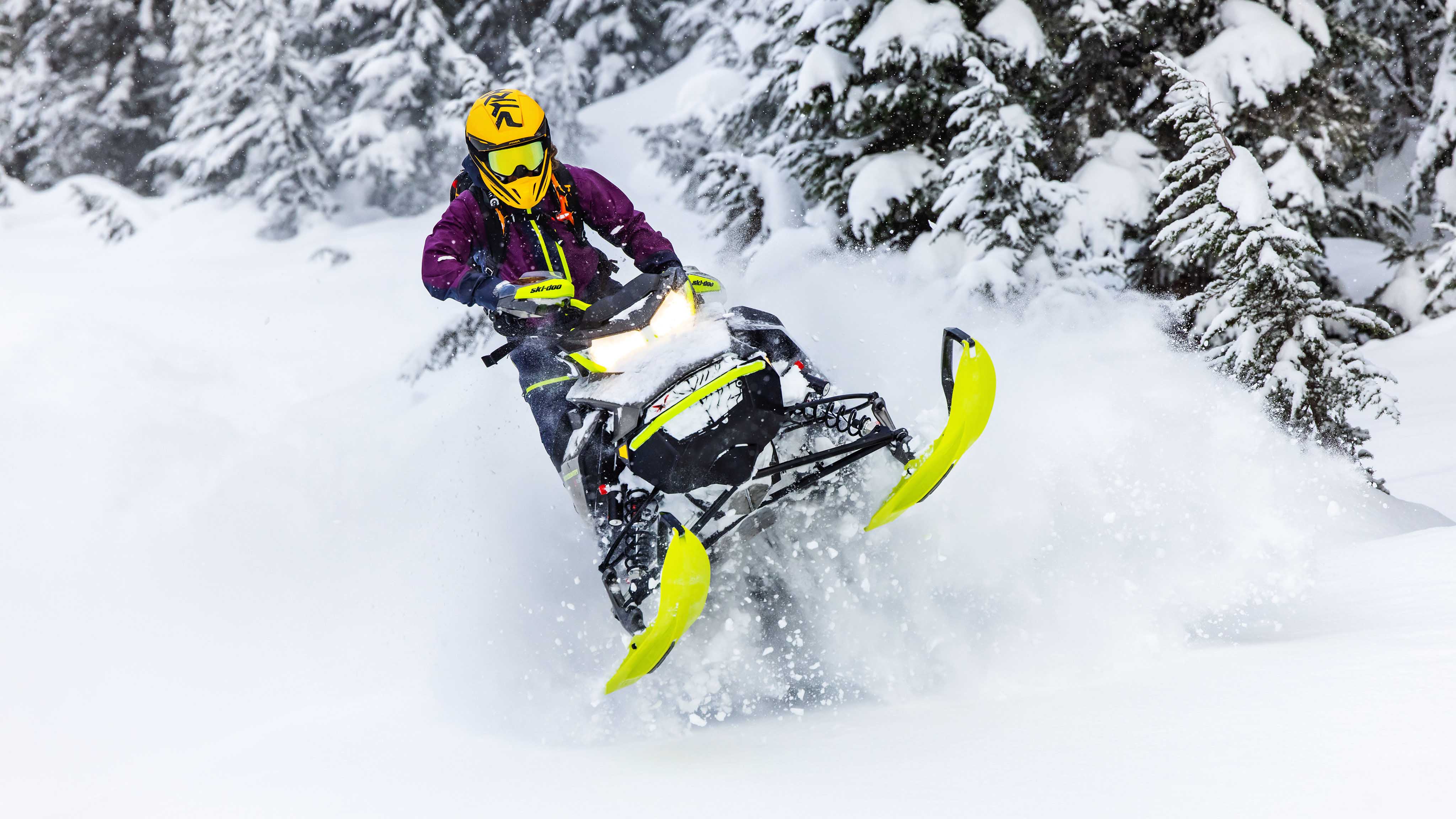 Woman riding in Deep-Snow with a Ski-Doo Crossover Snowmobile