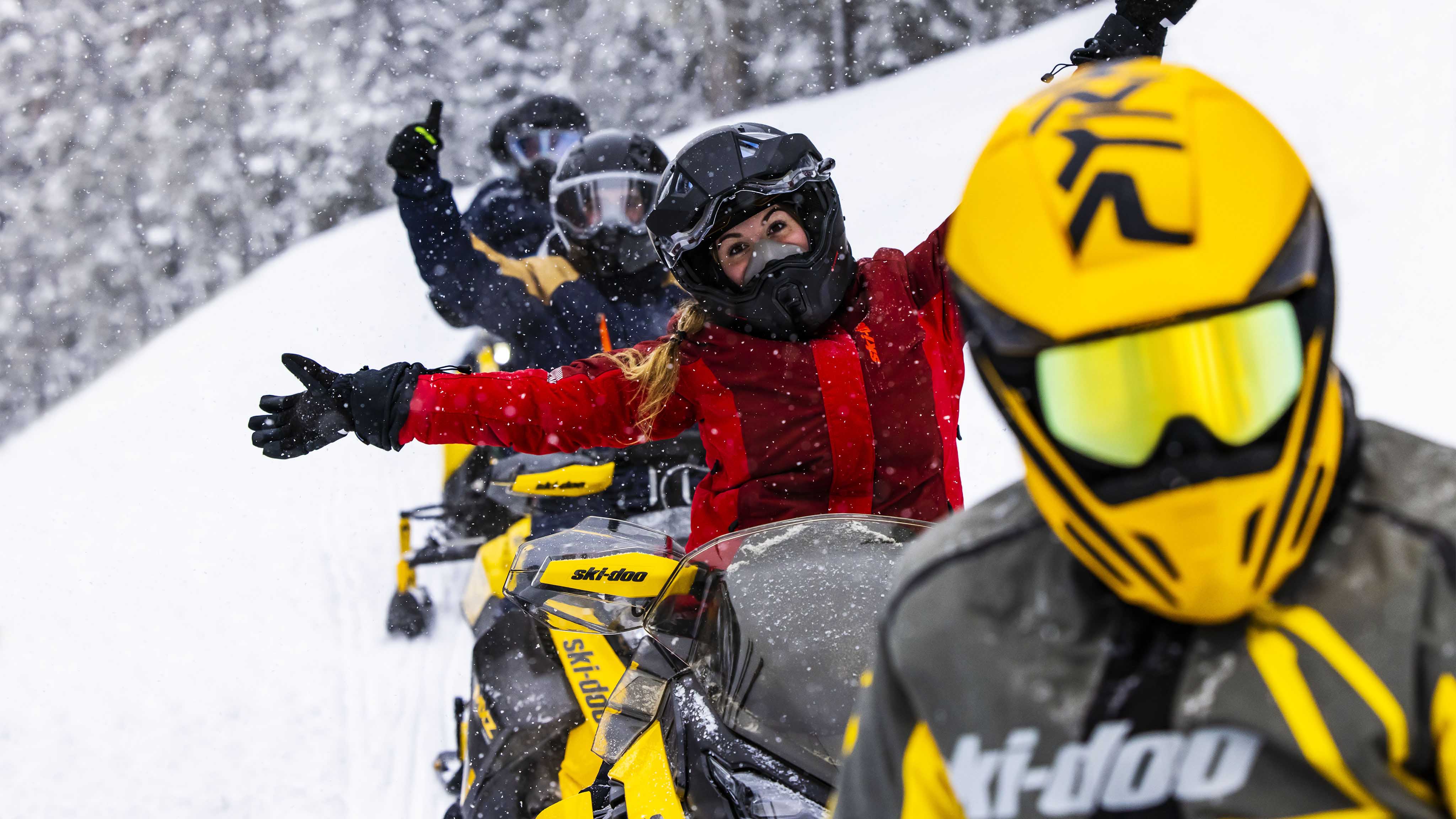 Happy family during a Ski-Doo snowmobile ride