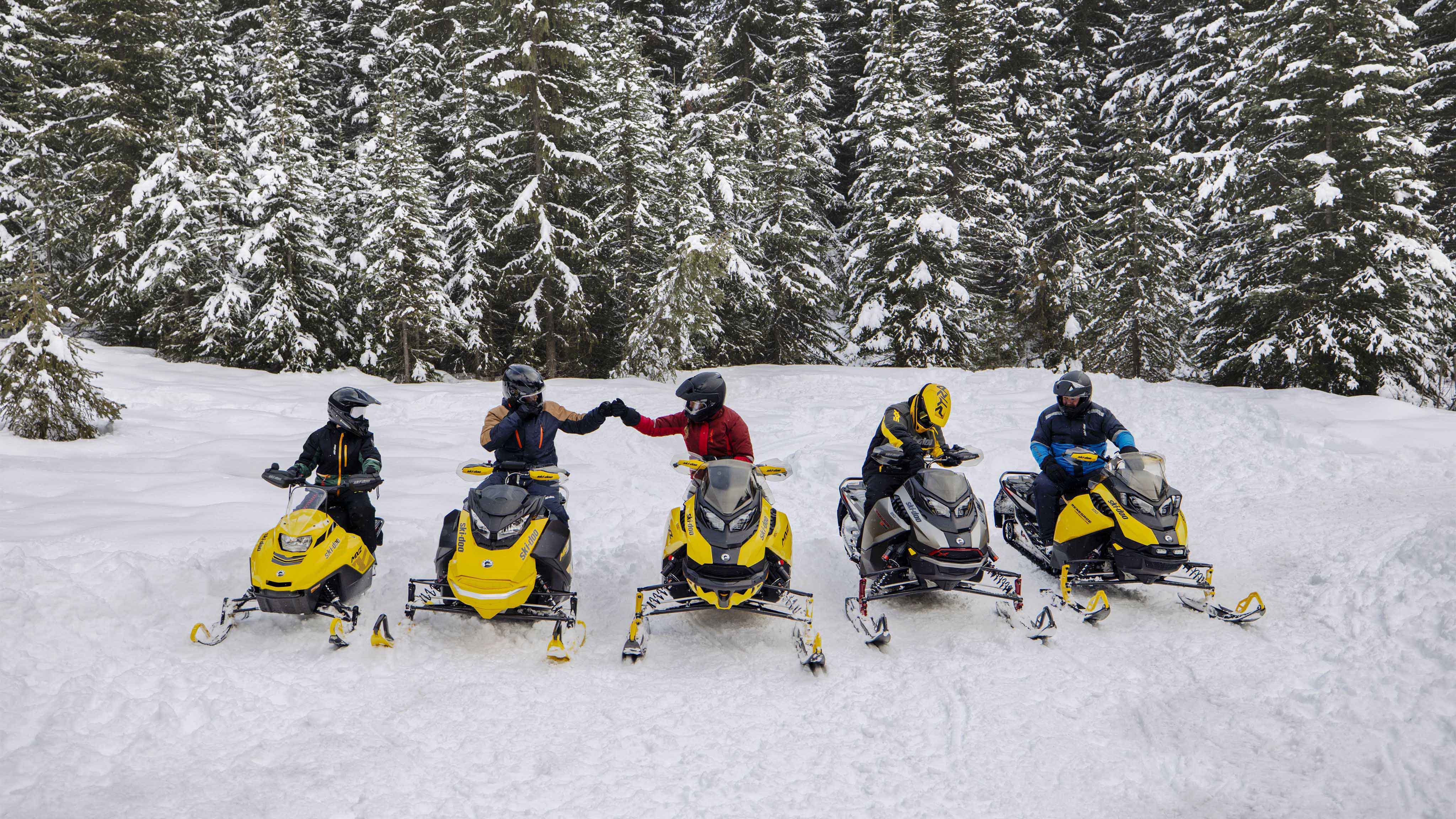 Family riding with their Ski-Doo trail sleds