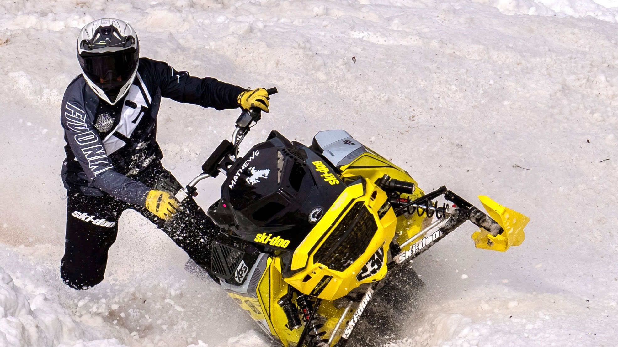 Blaine Mathews on a Ski-Doo snowmobile during a hillclimb race