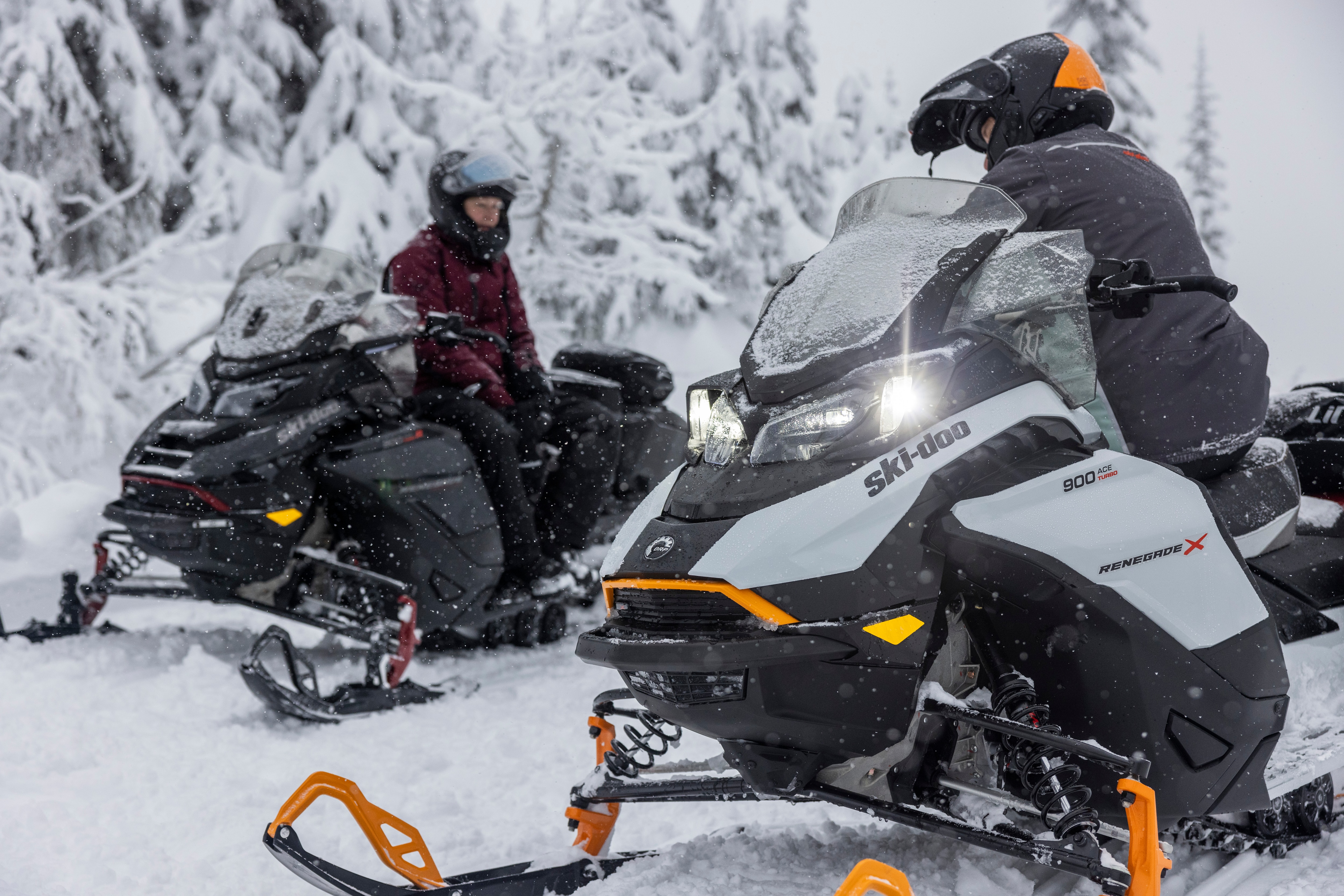 Two riders on their Ski-Doo snowmobile.