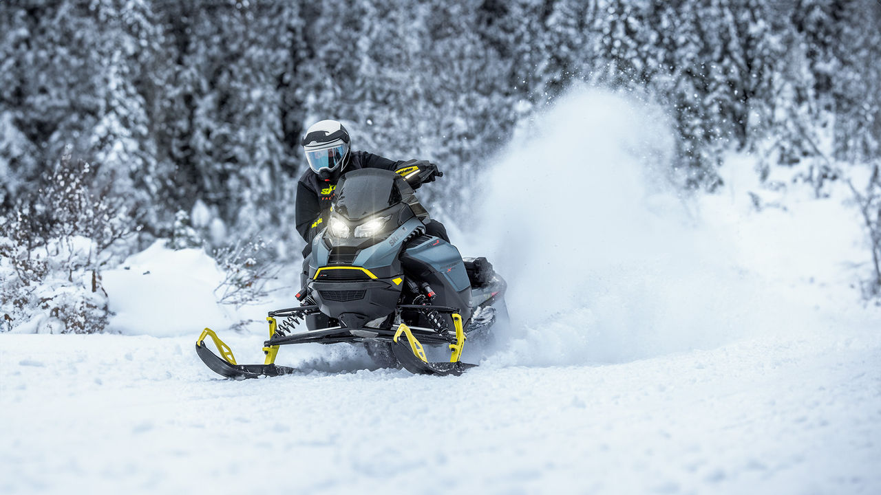 Ski-Doo rider making a turn on a snowy trail