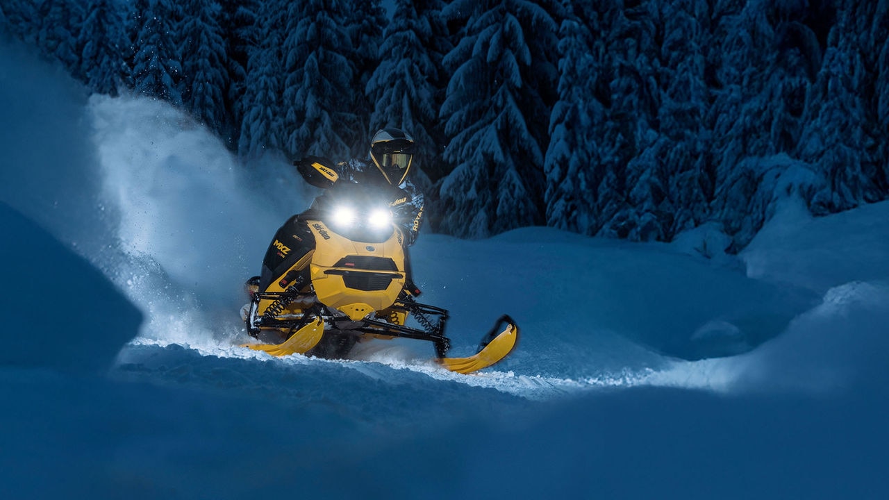 Ski-Doo rider making a turn on a snowy trail