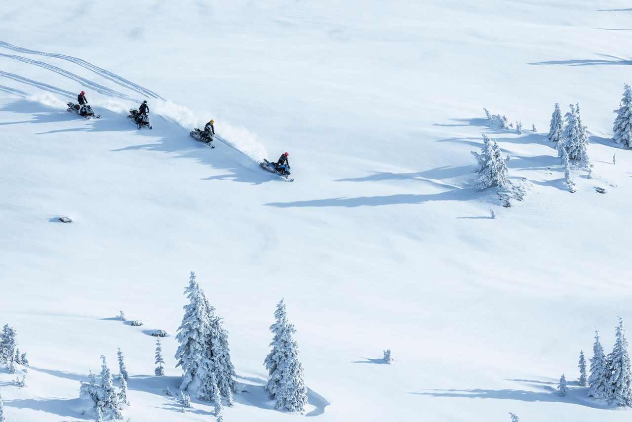 2026 Ski-Doo snowmobiles riding down a mountain